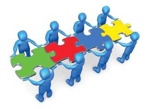 Royalty-free 3d computer generated clipart picture image of a team of 8 blue people holding up connected pieces to a colorful puzzle that spells out "team," symbolizing excellent teamwork, success and link exchanging.